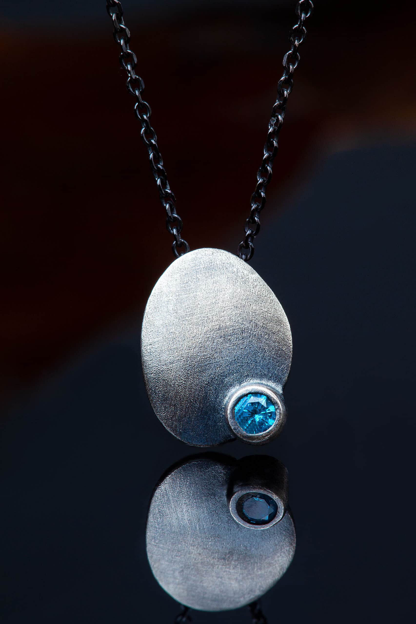 Silver necklace with blue zircon main