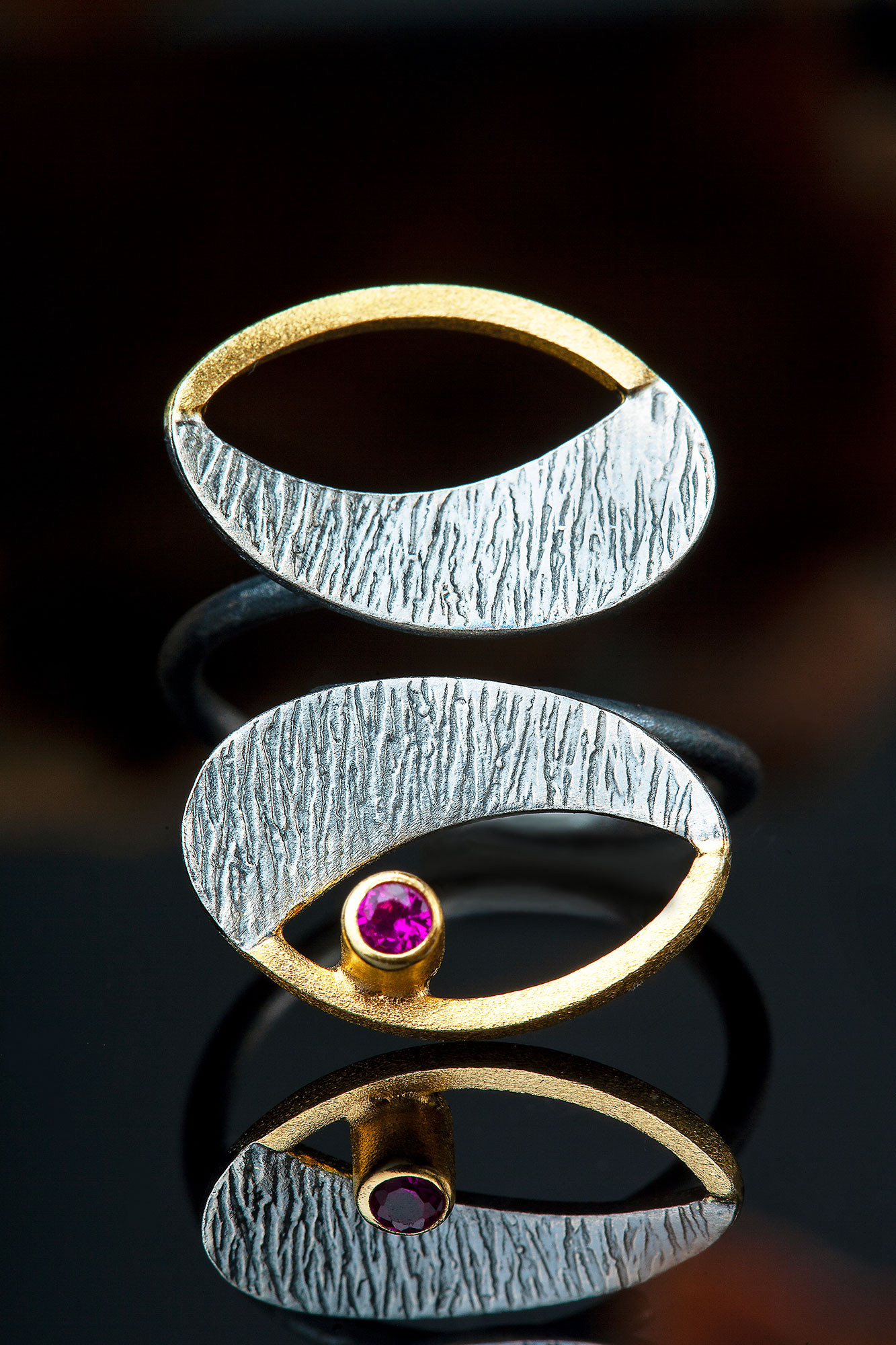 Textured handmade silver ring with fuchsia zircon main